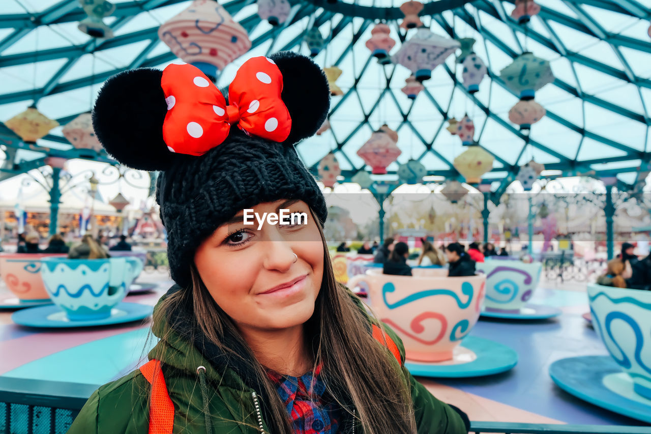 Portrait of smiling young woman at amusement park