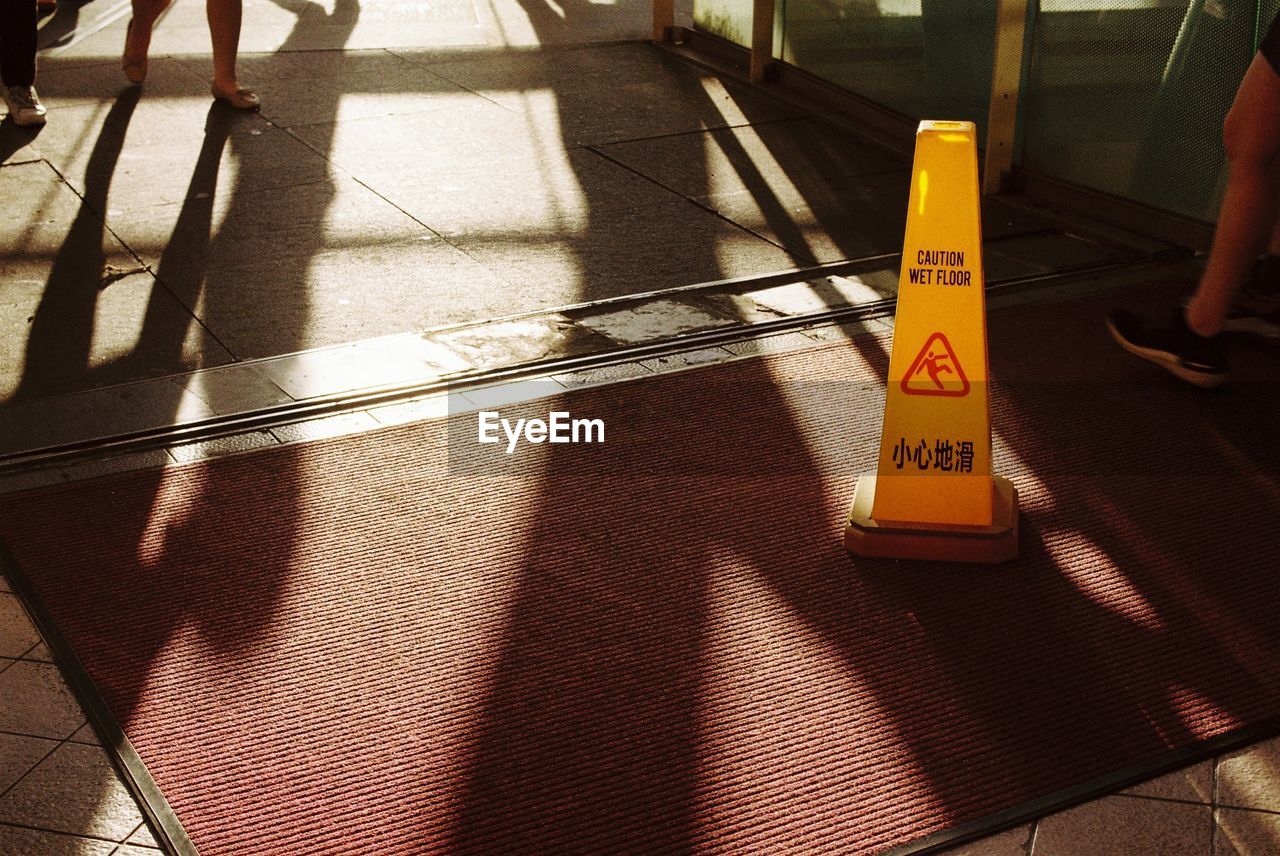 HIGH ANGLE VIEW OF TEXT ON ZEBRA CROSSING IN CITY