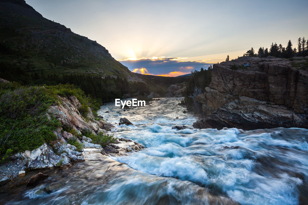 Scenic view of river against sky during sunset