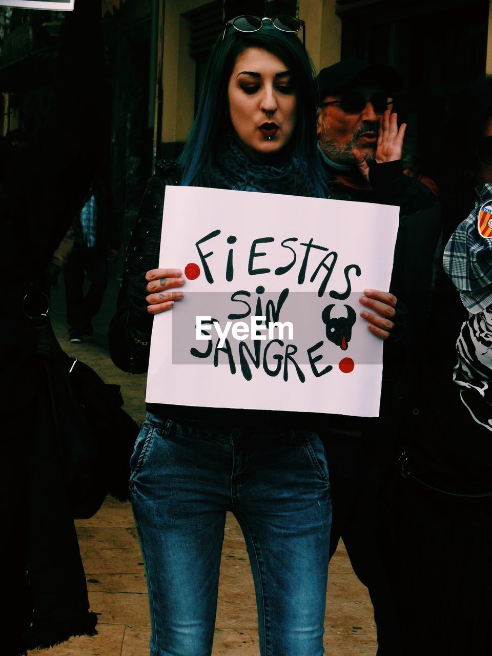 Woman holding placard during poster