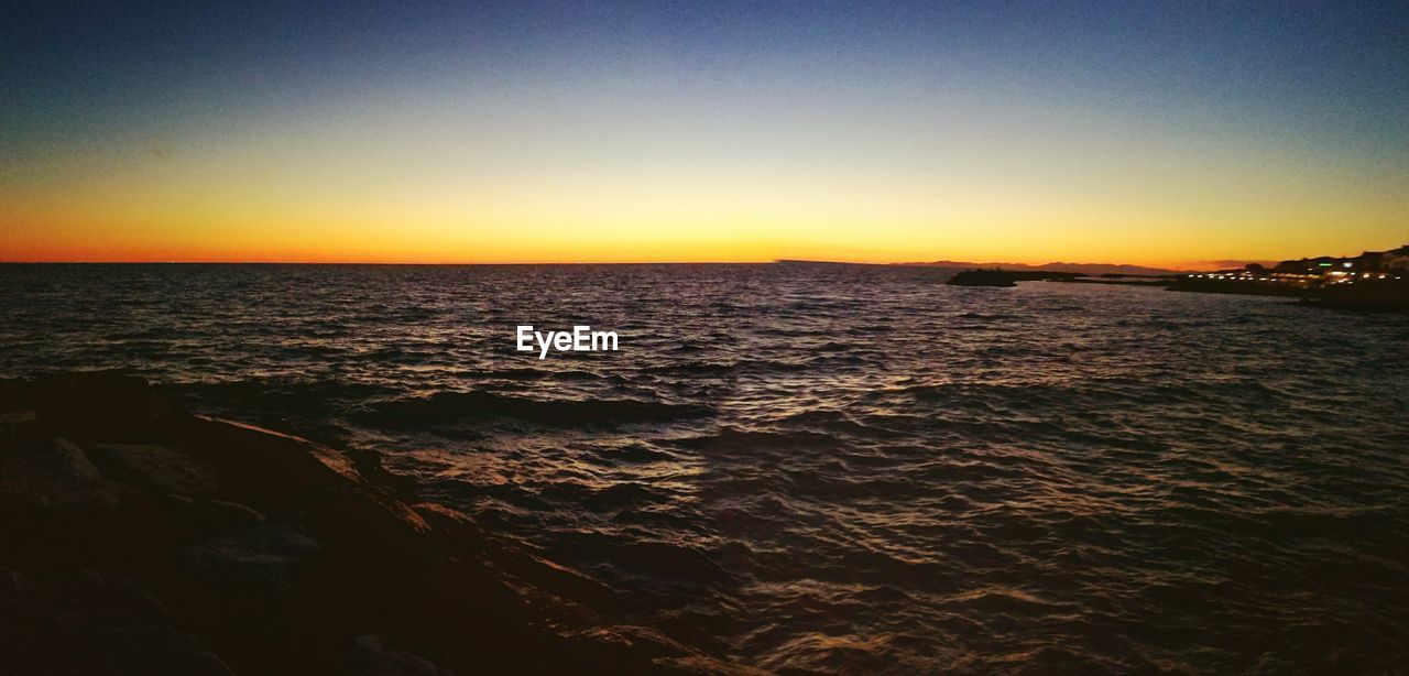 Panoramic shot of sea against clear sky during sunset