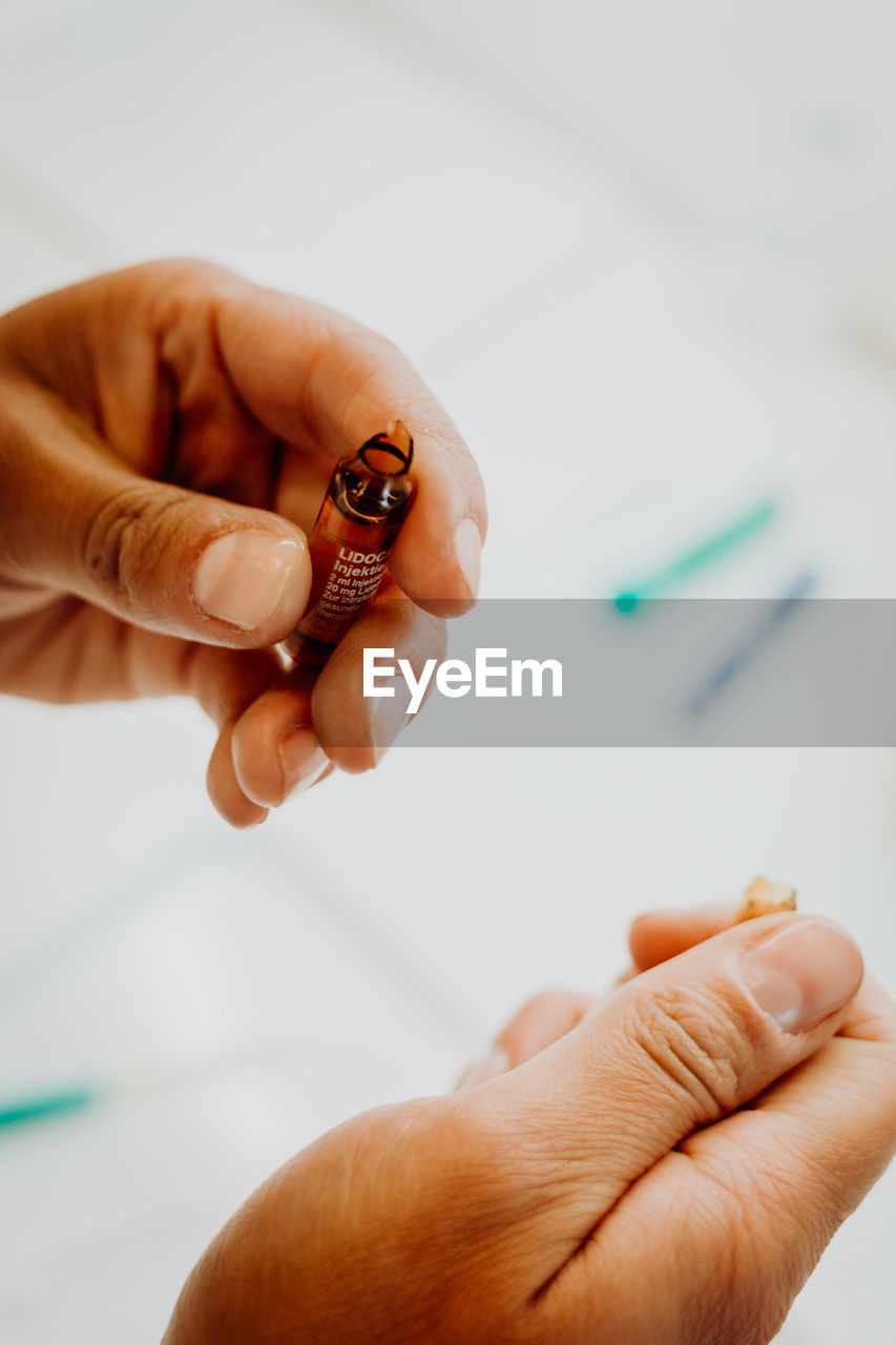 Close-up of human hand holding syringe