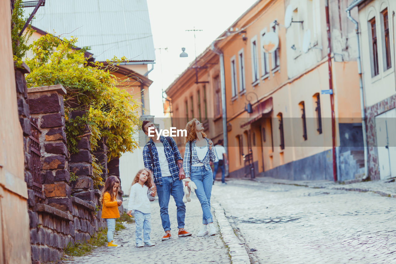 People walking on street amidst buildings