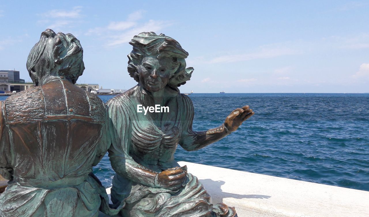 STATUE AGAINST SEA AND SKY