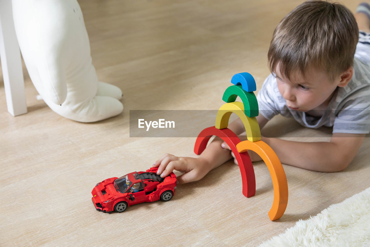 high angle view of boy playing with toy on floor