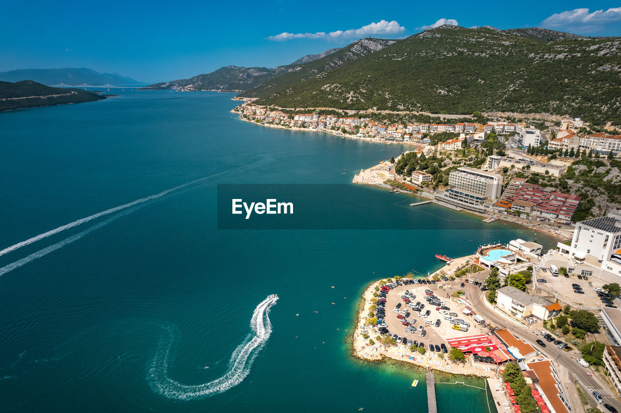 high angle view of sea and buildings against sky