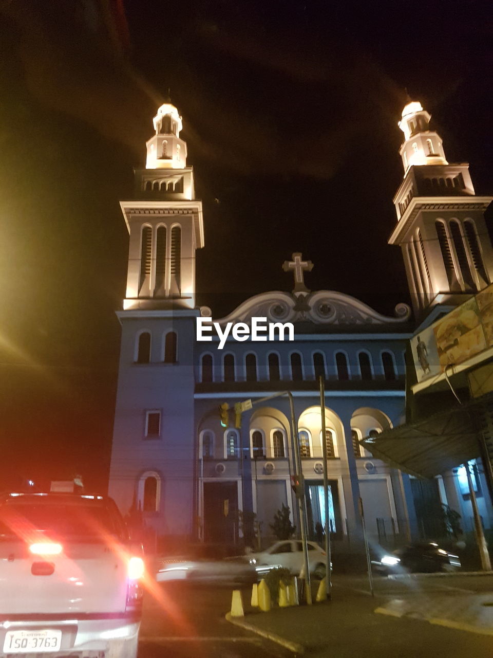 LOW ANGLE VIEW OF ILLUMINATED CATHEDRAL AGAINST SKY