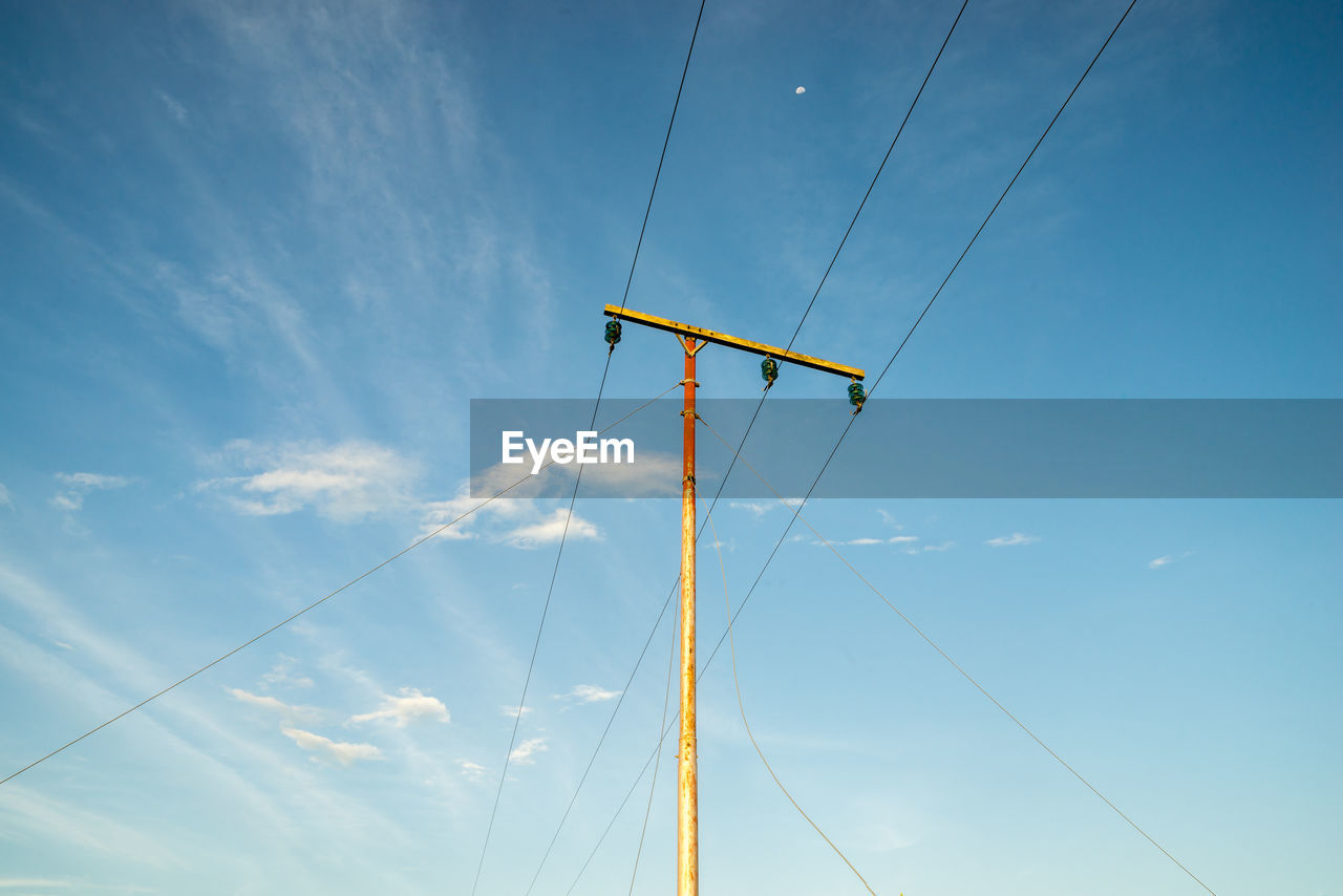 Low angle view of electric pole against sky