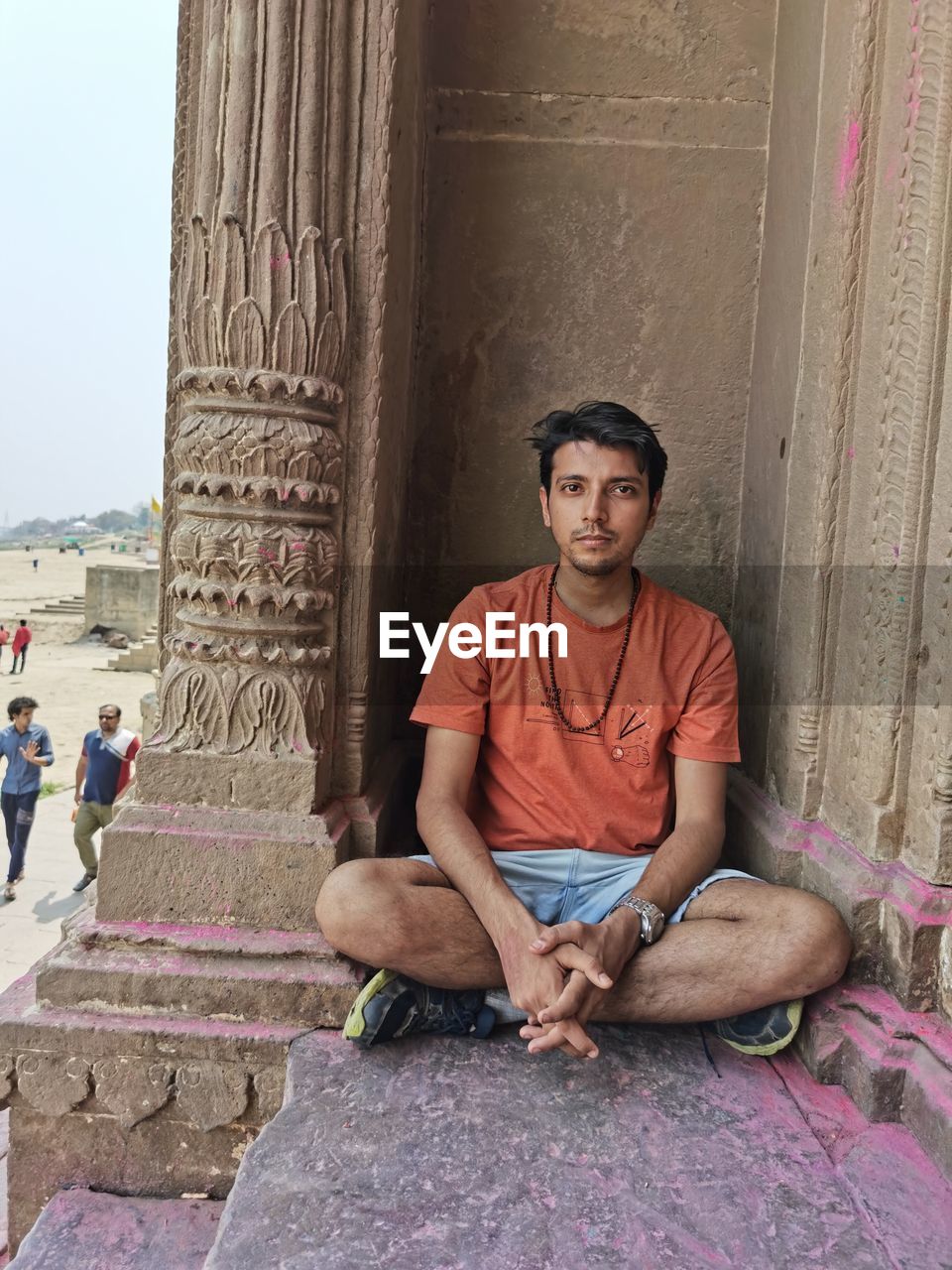 Indian guy sitting in varanasi holi time