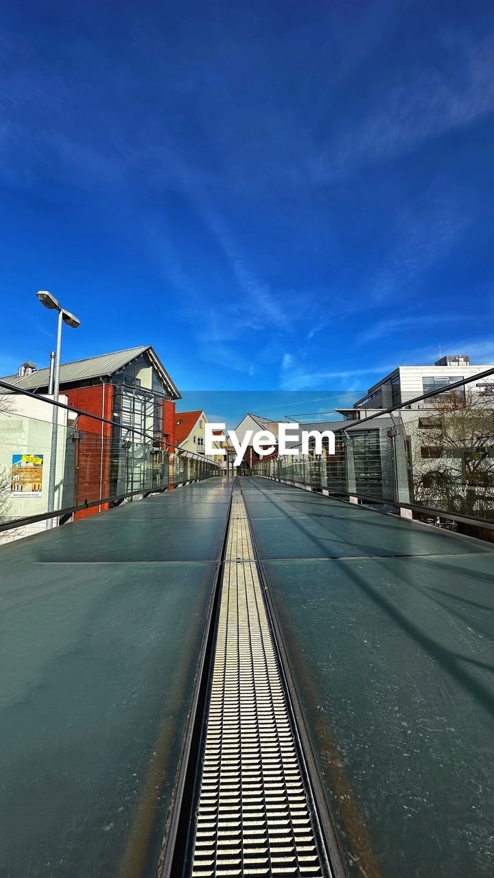 architecture, sky, built structure, building exterior, transportation, city, transport, rail transportation, nature, railroad track, track, cityscape, urban area, cloud, no people, street, blue, the way forward, road, railroad station, travel, building, travel destinations, lane, outdoors, evening, mode of transportation, day, vanishing point, diminishing perspective