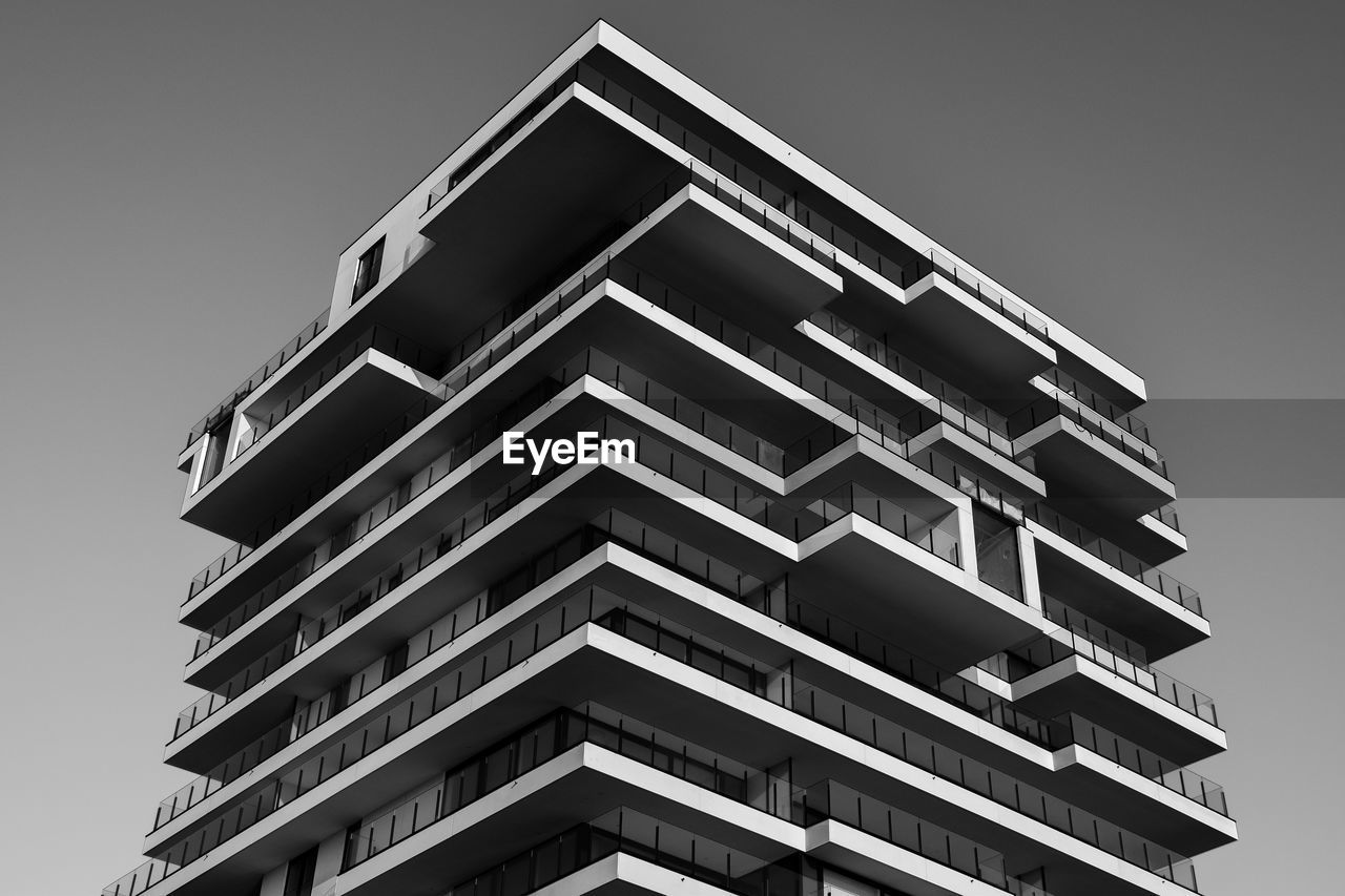 architecture, built structure, building exterior, black and white, tower block, building, low angle view, monochrome, monochrome photography, brutalist architecture, city, no people, sky, skyscraper, residential district, pattern, facade, apartment, line, house, window, clear sky, tower, repetition, nature, white
