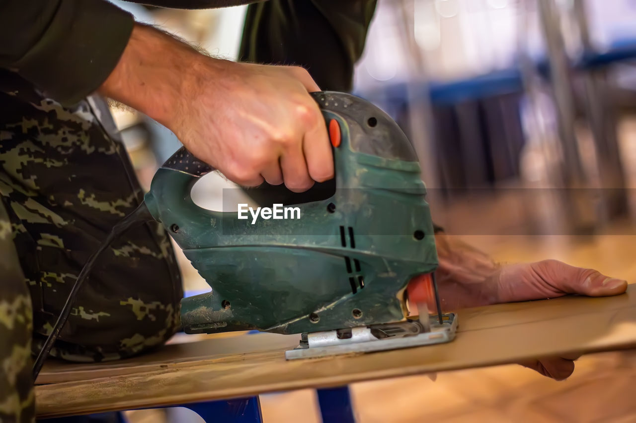 midsection of man working in factory