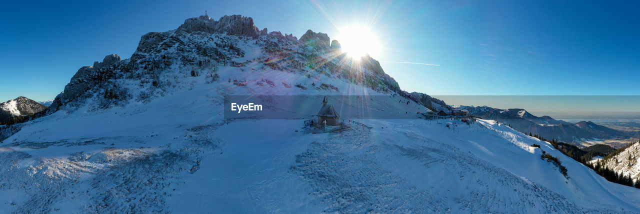 Panoramic view of snowcapped mountains against sky