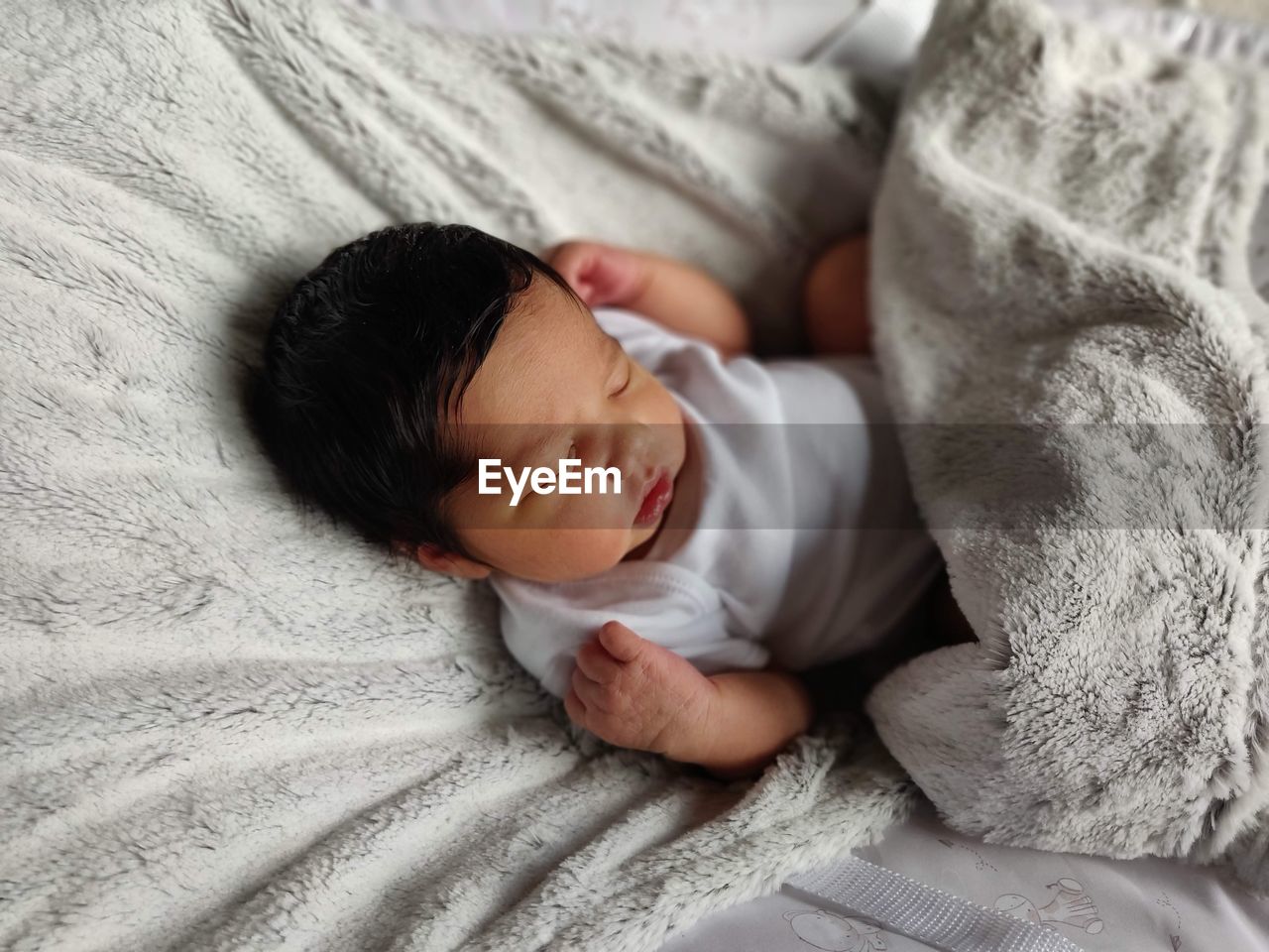 High angle view of baby sleeping on a rocking chair