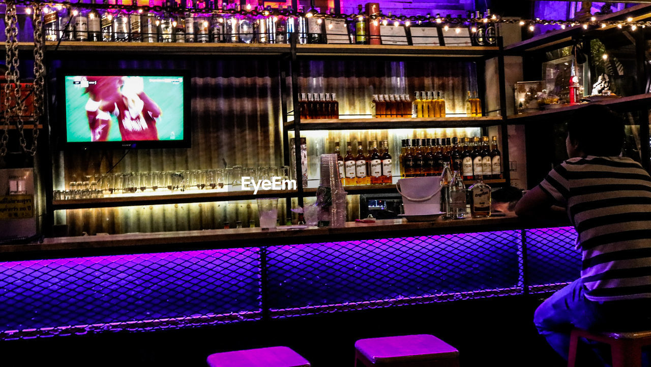 FULL FRAME SHOT OF WINE BOTTLES ON BAR