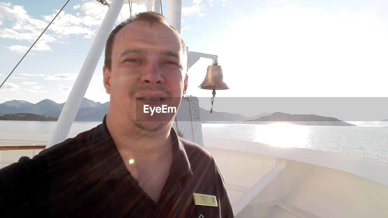 PORTRAIT OF MAN IN BOAT SAILING ON SEA