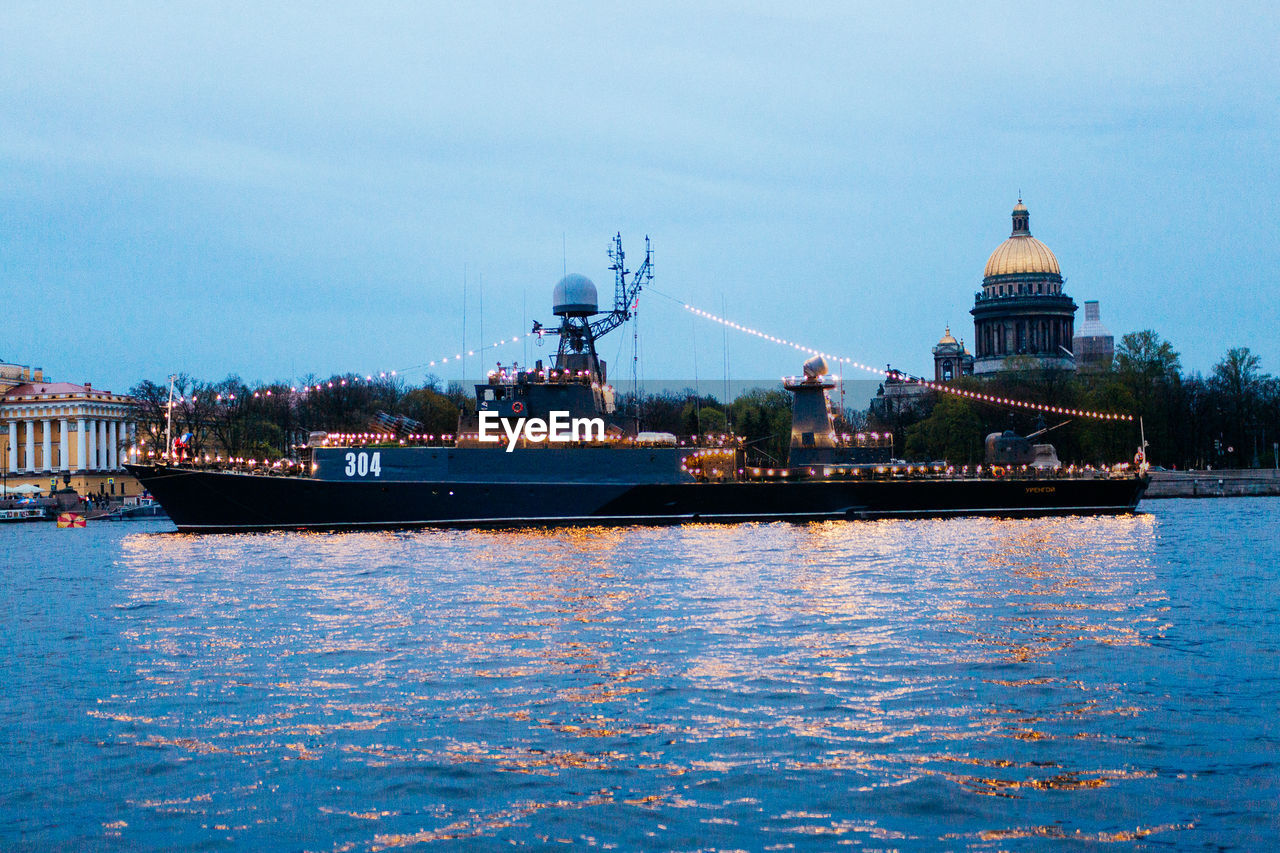 VIEW OF RIVER WITH BUILDINGS IN BACKGROUND