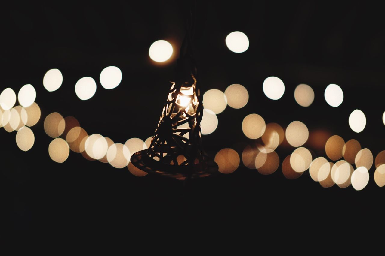 Low angle view of lantern against illuminated lights