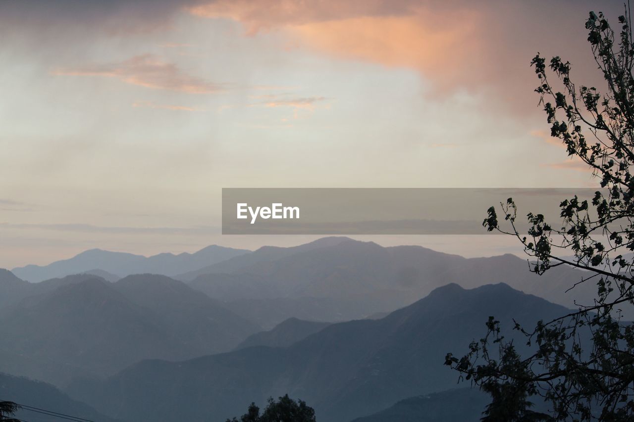 Scenic view of silhouette mountains against sky at sunset