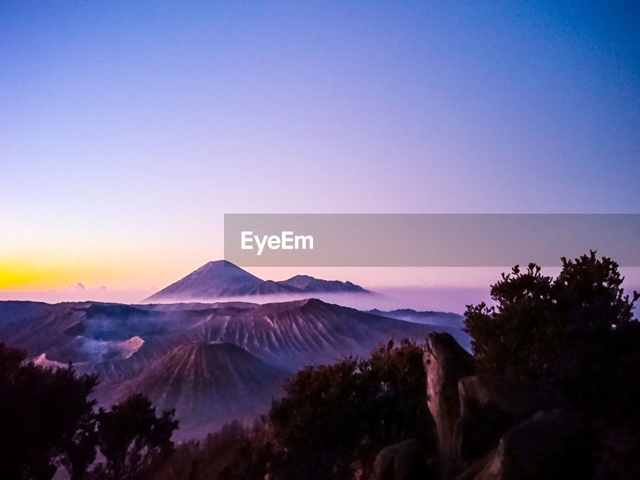 View of volcanic mountain against sky during sunset