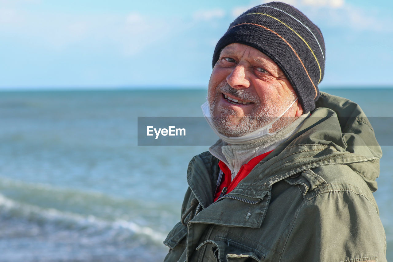 Portrait of man in sea against sky