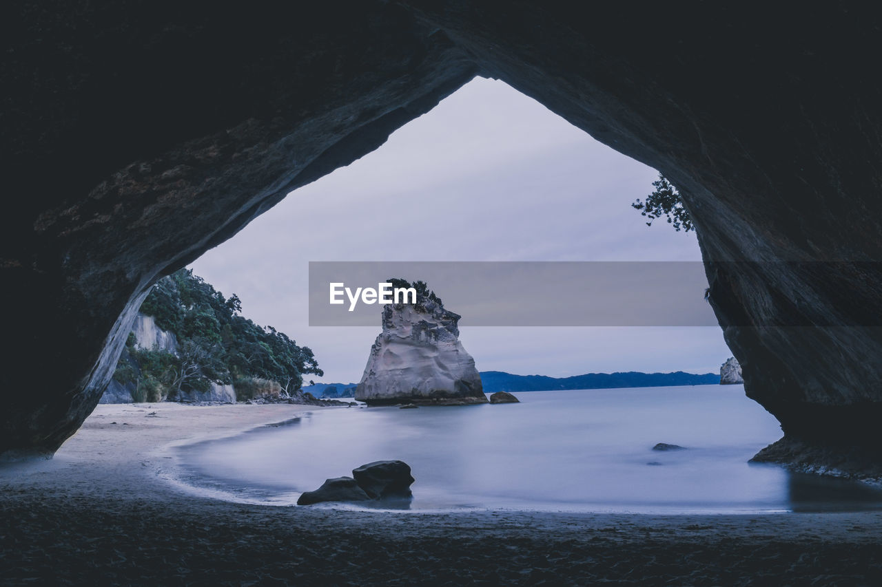 Scenic view of sea seen through cave