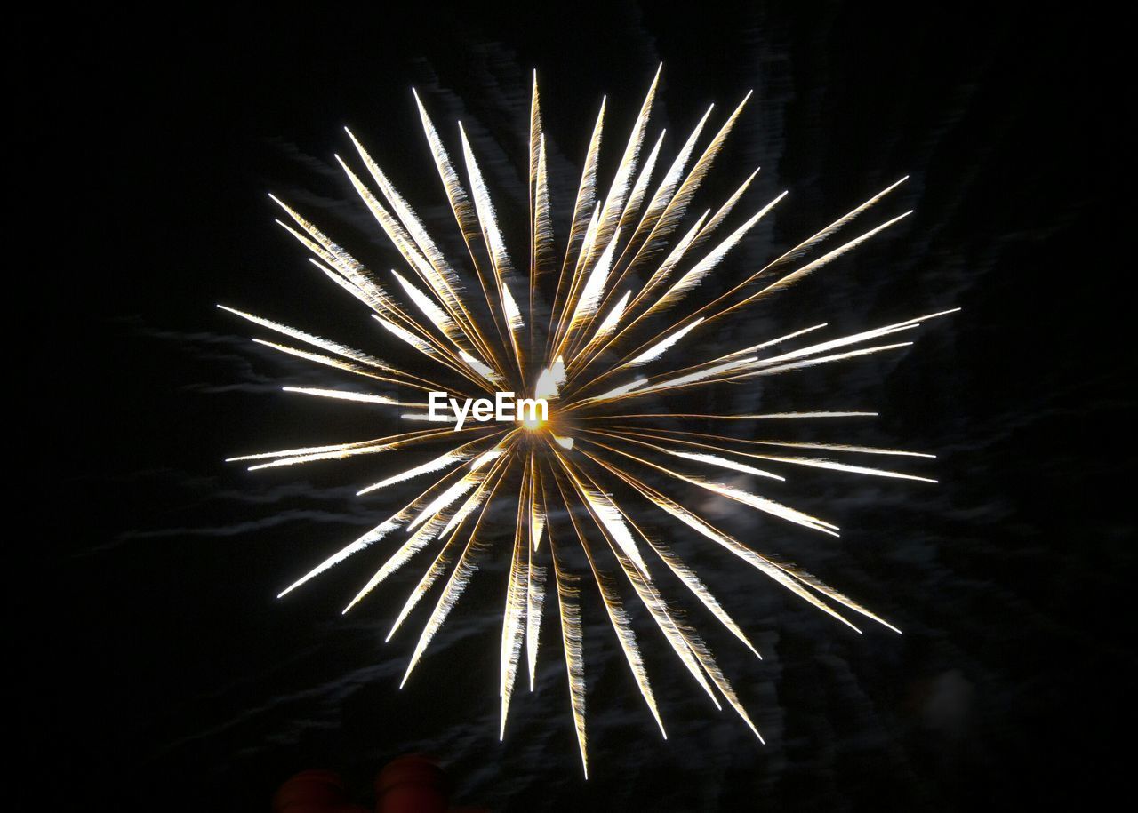 Low angle view of firework display at night