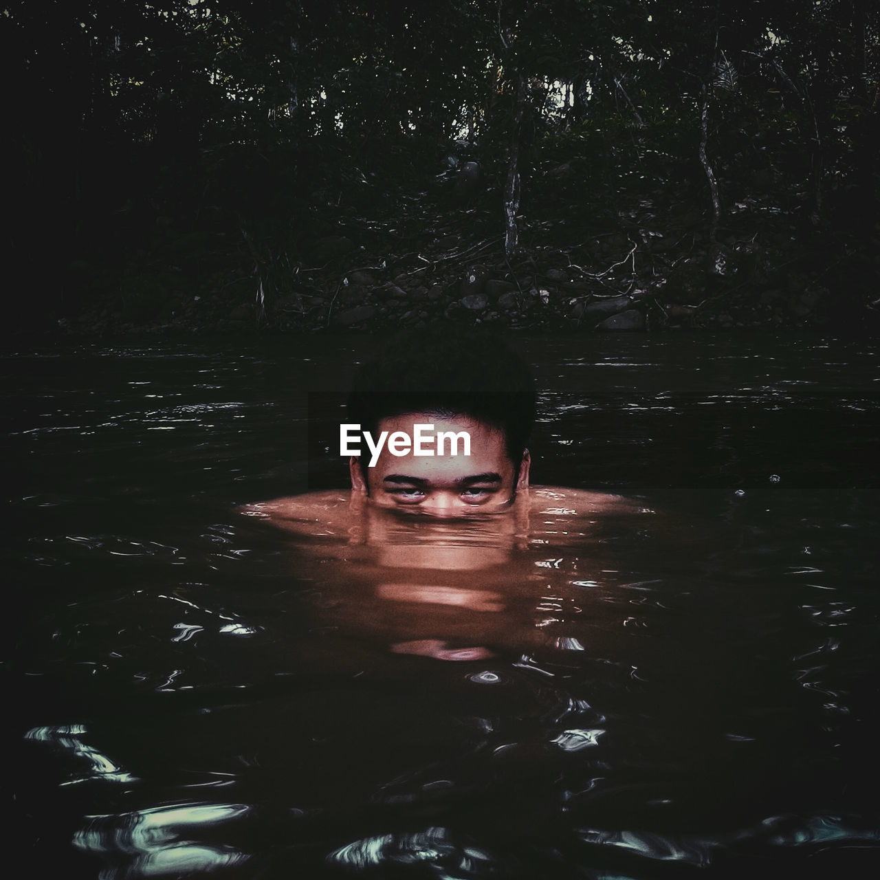 Portrait of man swimming in lake
