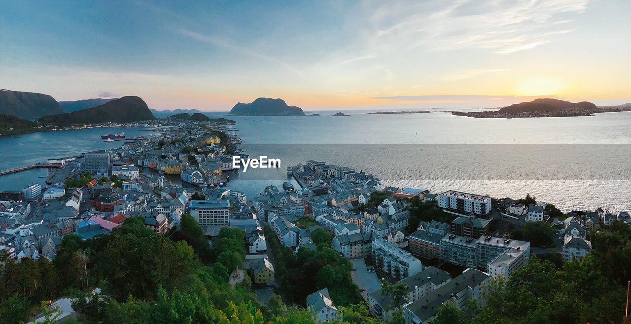 High angle view of city by sea against sky