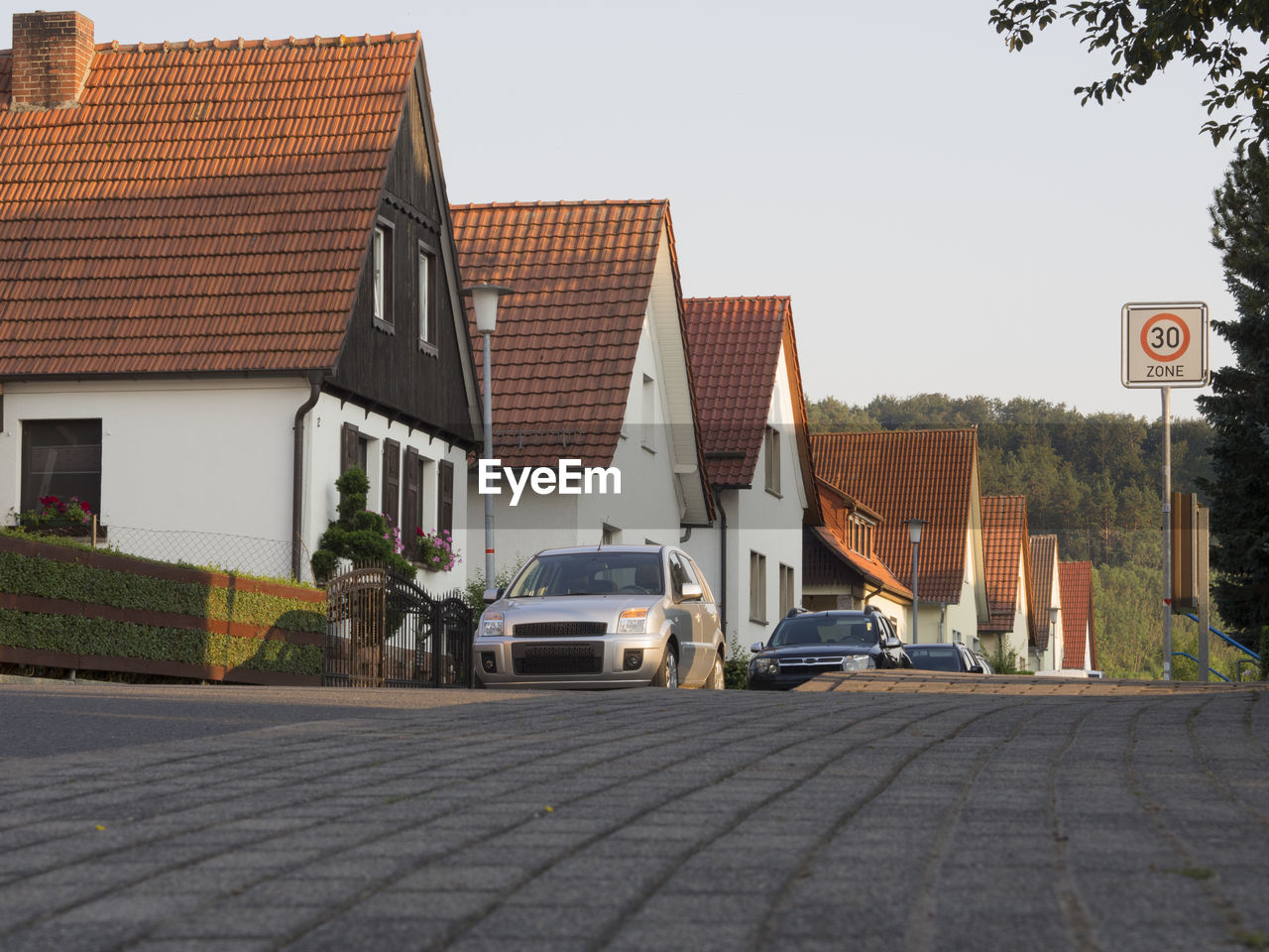 CARS PARKED ON ROAD AGAINST BUILDINGS