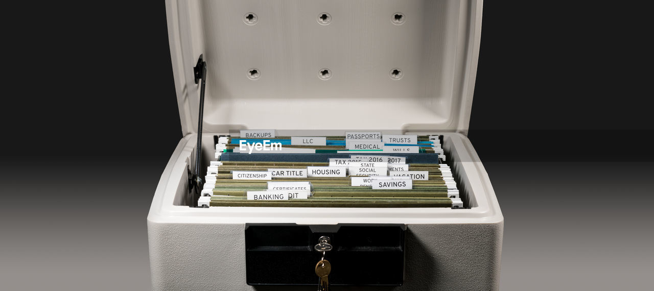 Close-up of documents arranged in safe locker