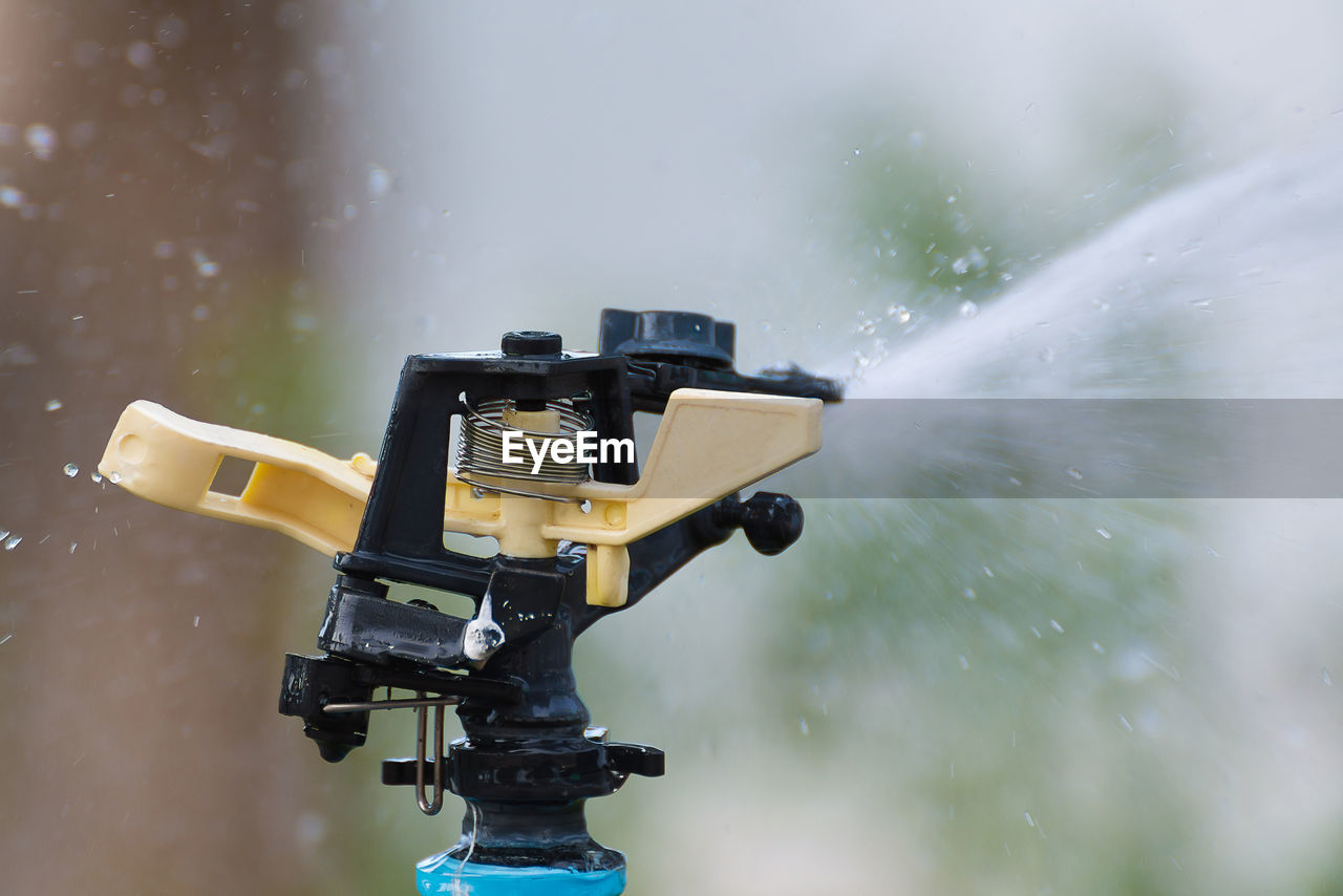 LOW ANGLE VIEW OF CAMERA AGAINST WATER