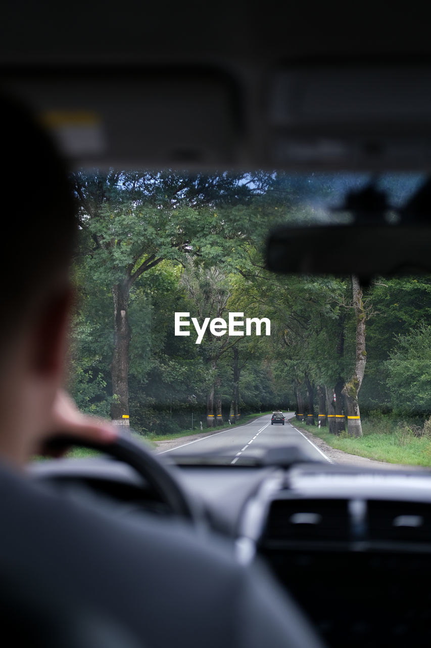 side view of car seen through windshield