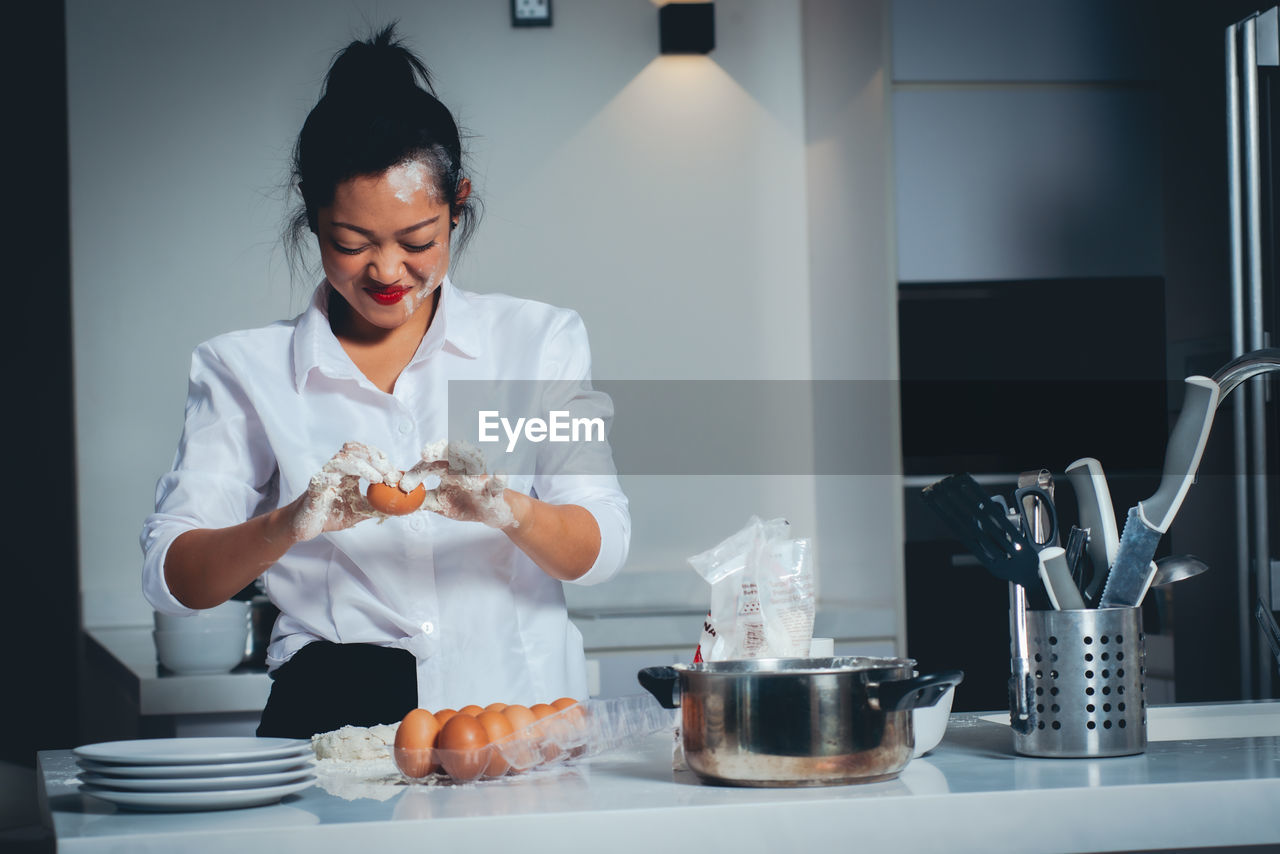 Office worker cooking at home after coming back from work.