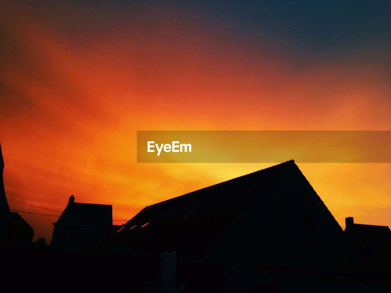 LOW ANGLE VIEW OF SILHOUETTE BUILDINGS AGAINST DRAMATIC SKY