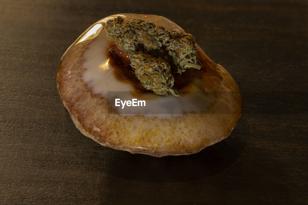 Marijuana flower on a stone on low light