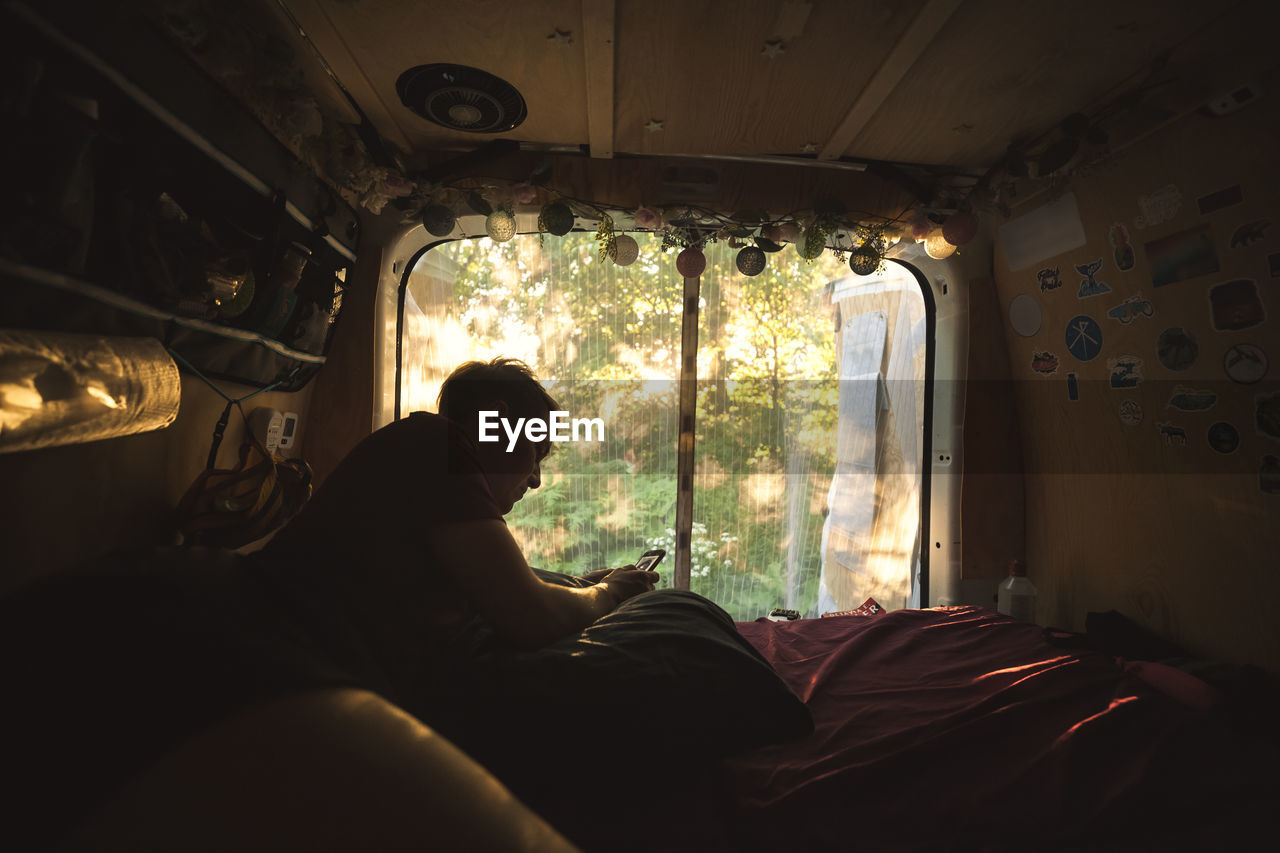 Young man resting in camper van