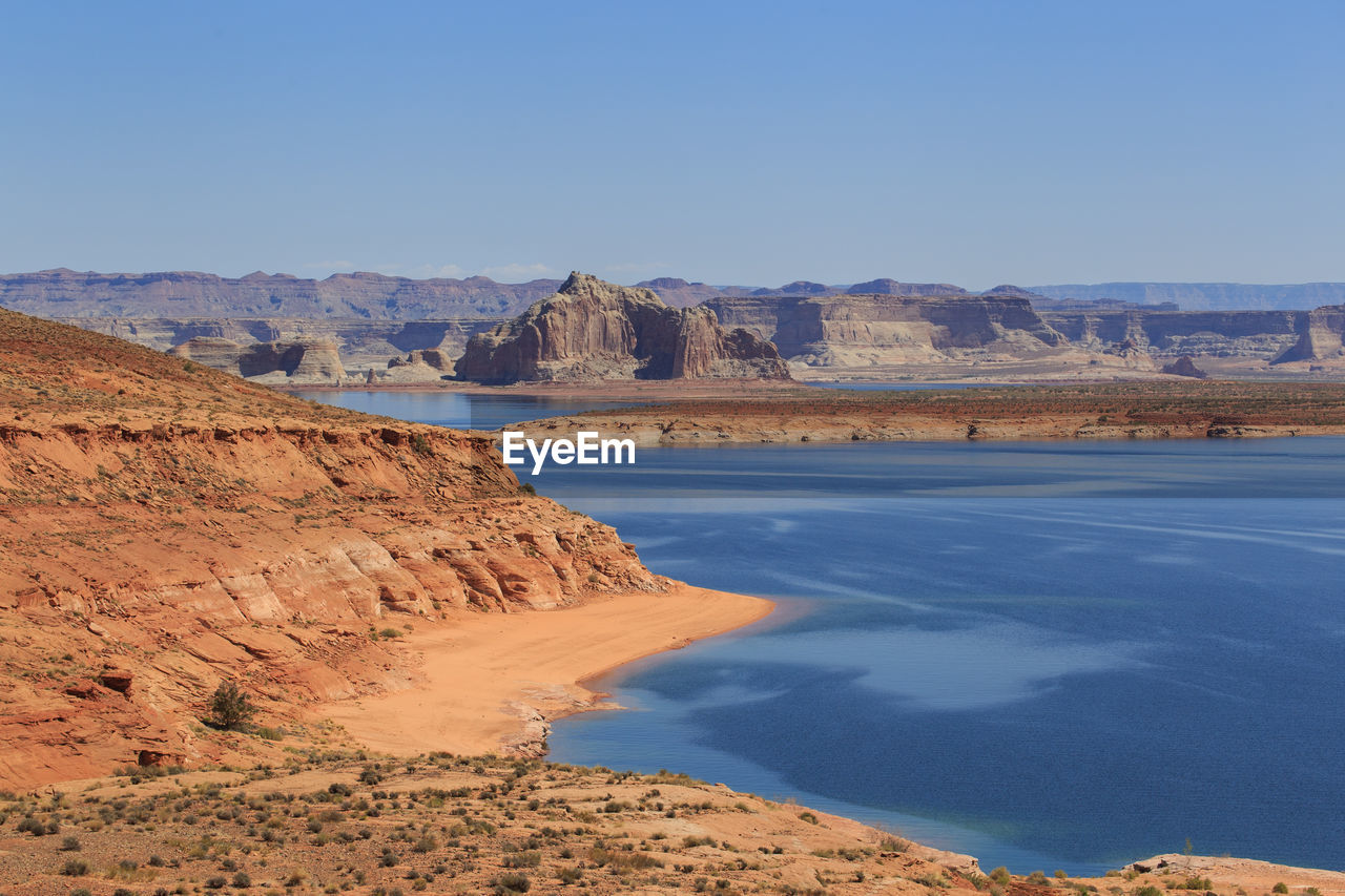 Scenic view of desert against clear blue sky