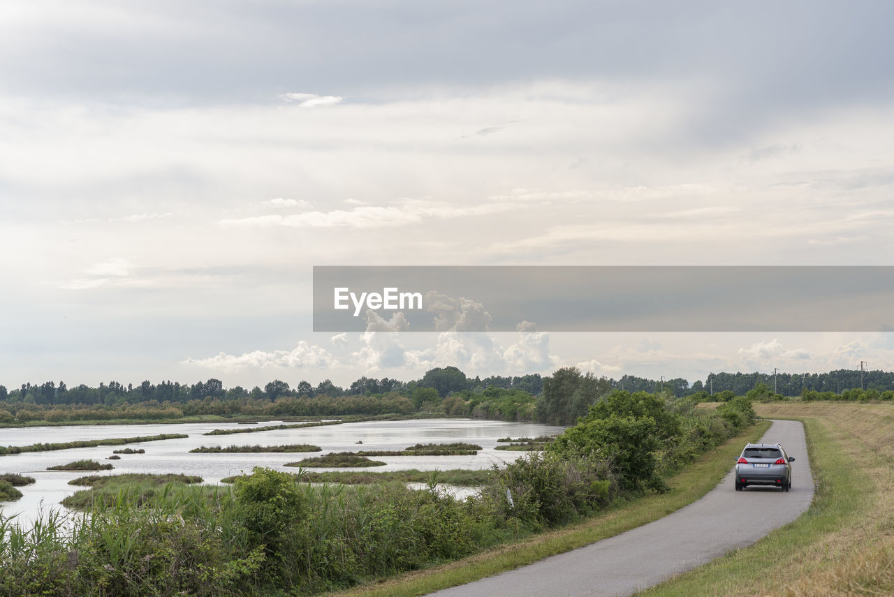 CARS ON ROAD AGAINST SKY