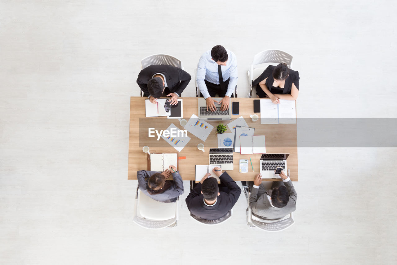 High angle view of business people discussing in meeting at office