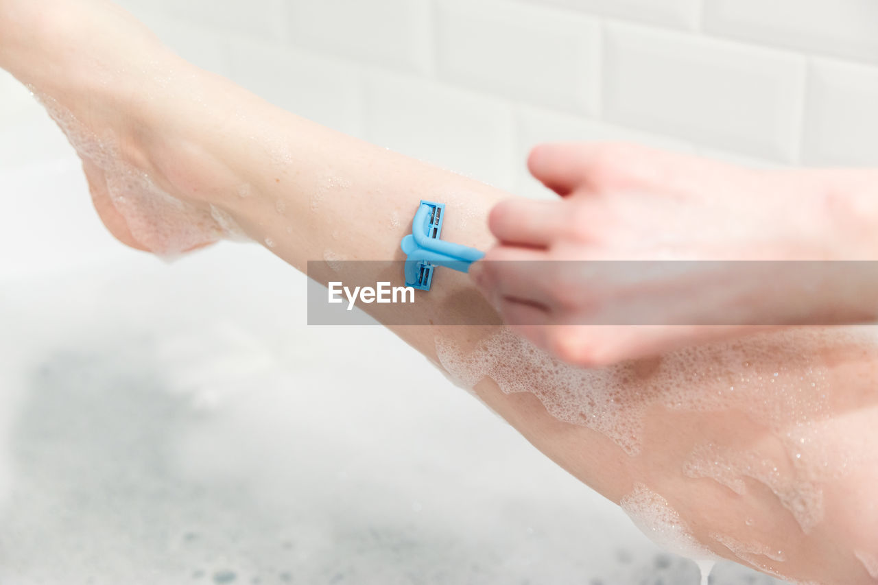CLOSE-UP OF HAND ON WET WALL