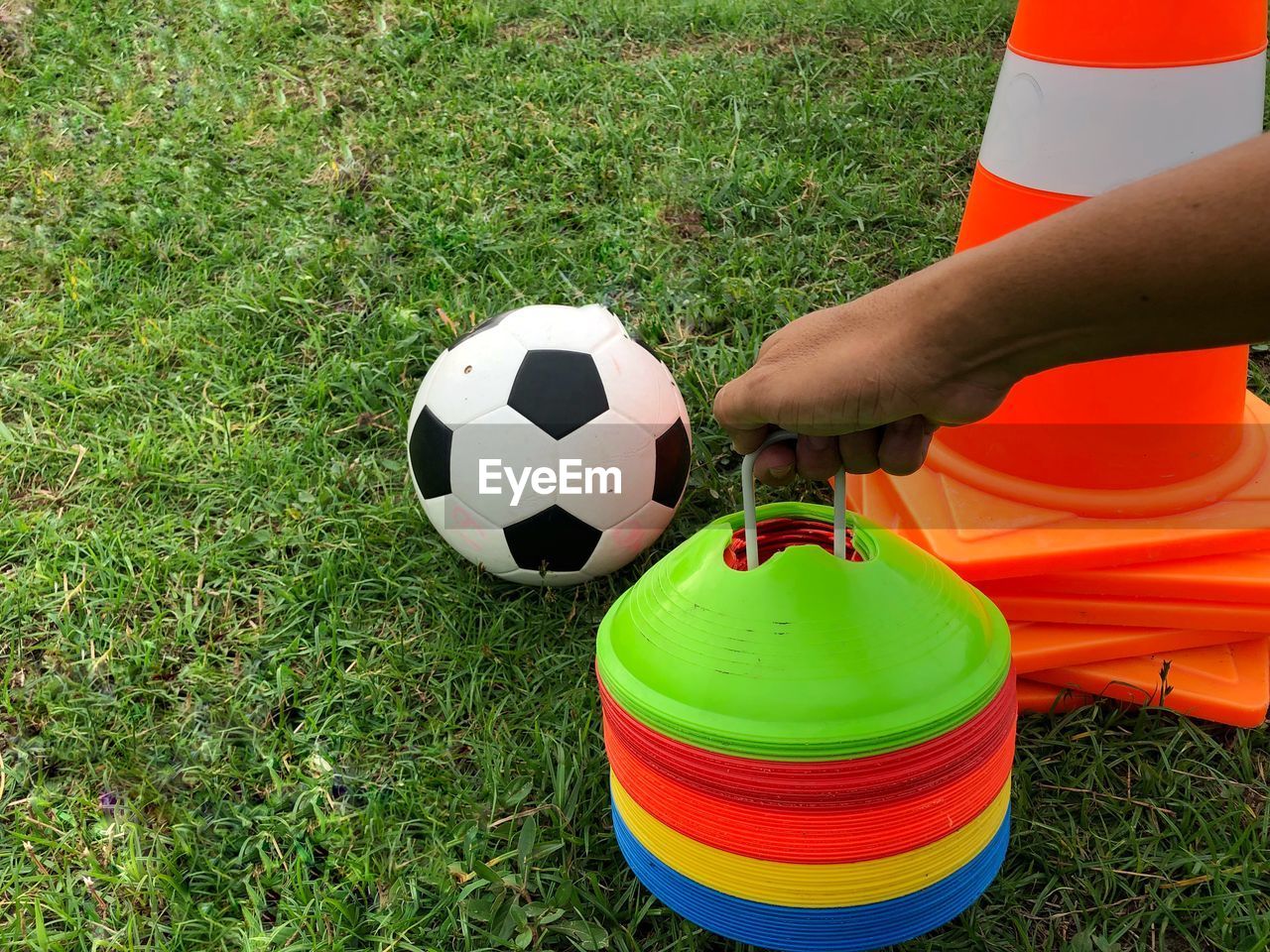 MAN PLAYING SOCCER BALL ON GRASS