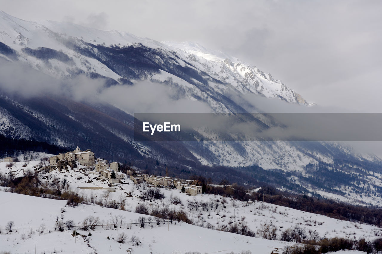 Scenic view of snow covered mountains against sky