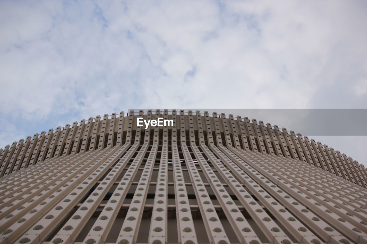 Low angle view of building against cloudy sky