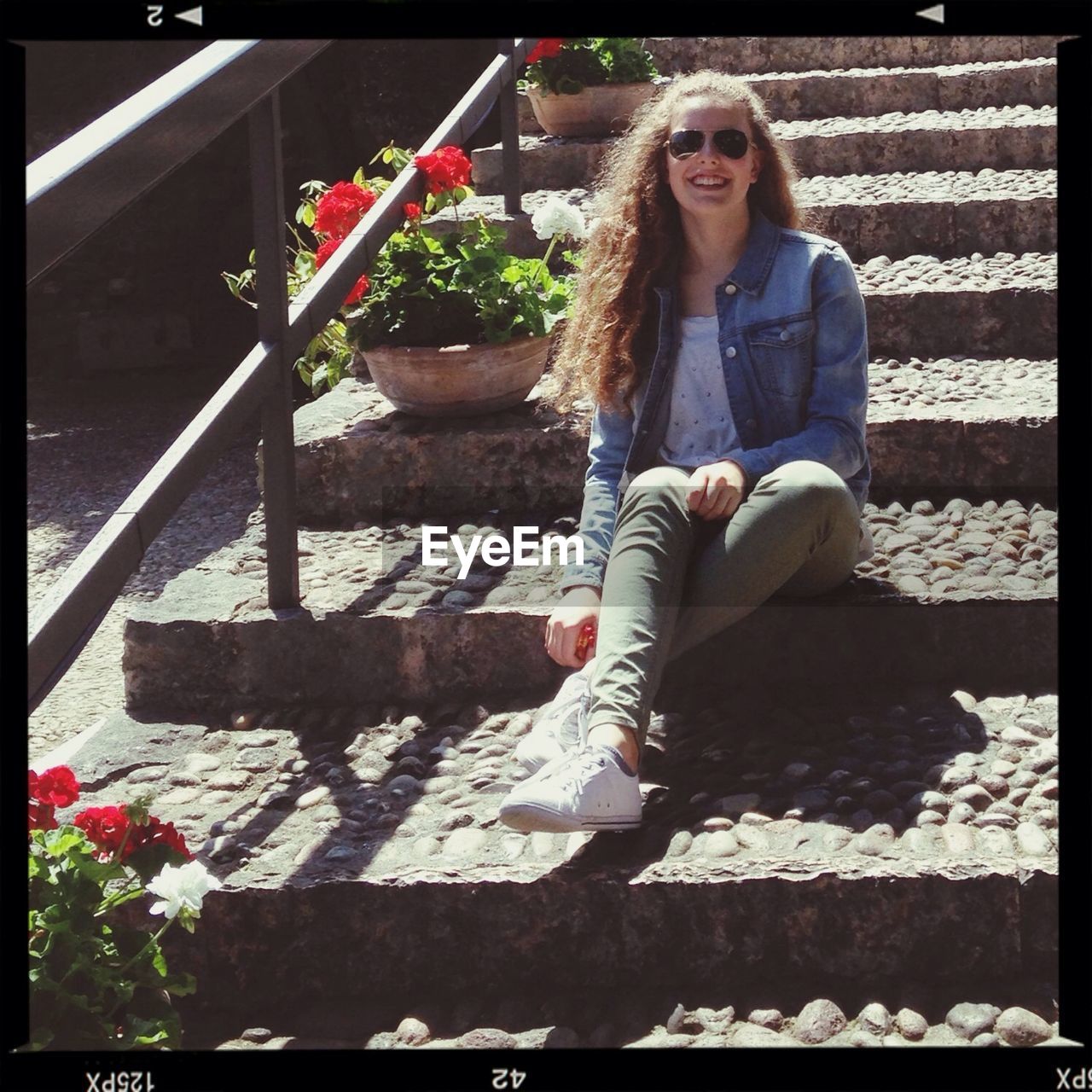 Woman sitting on staircase and smiling