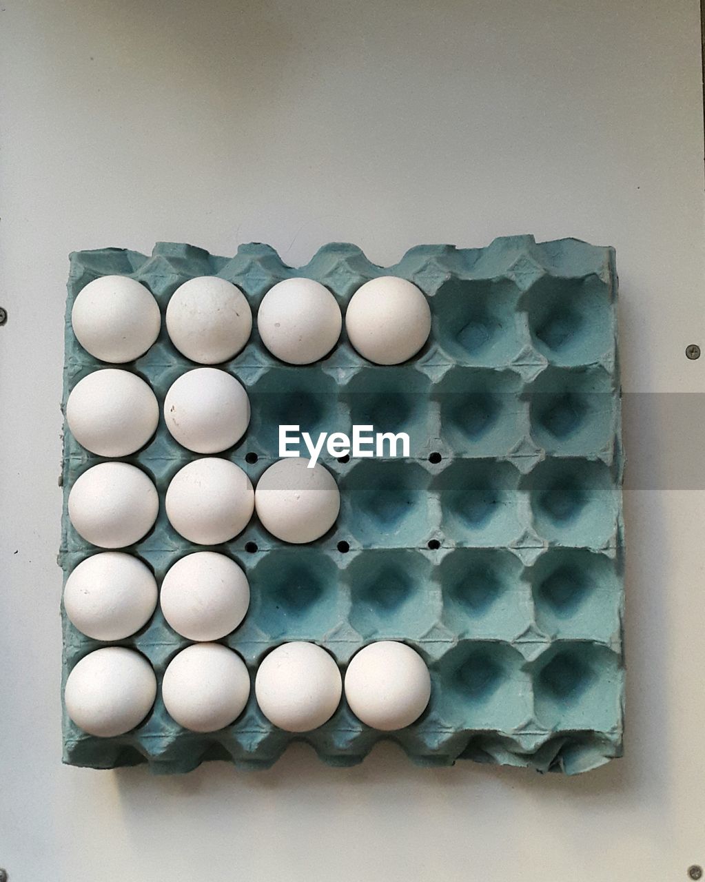 High angle view of eggs in carton on table