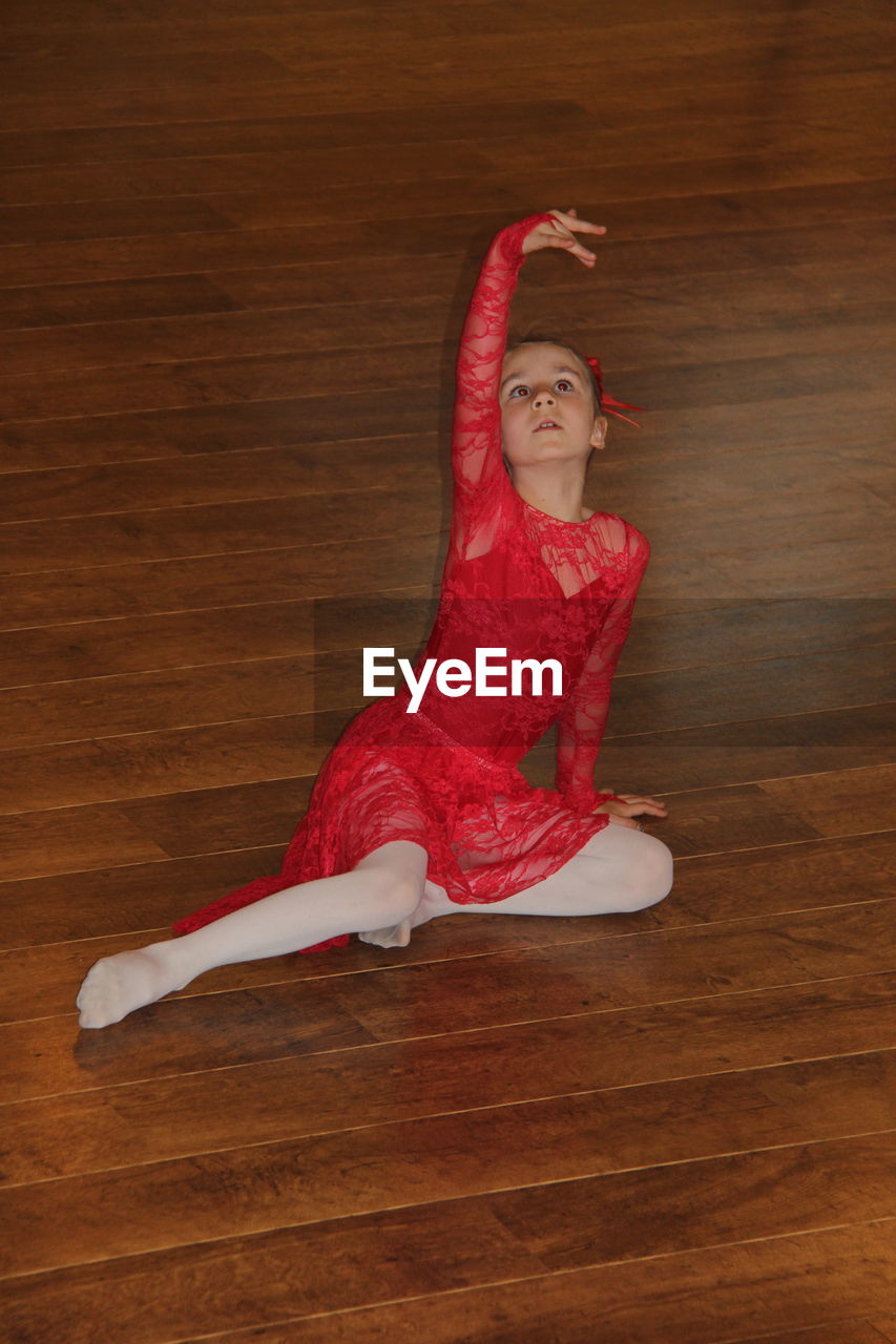 PORTRAIT OF YOUNG WOMAN WEARING MASK ON FLOOR