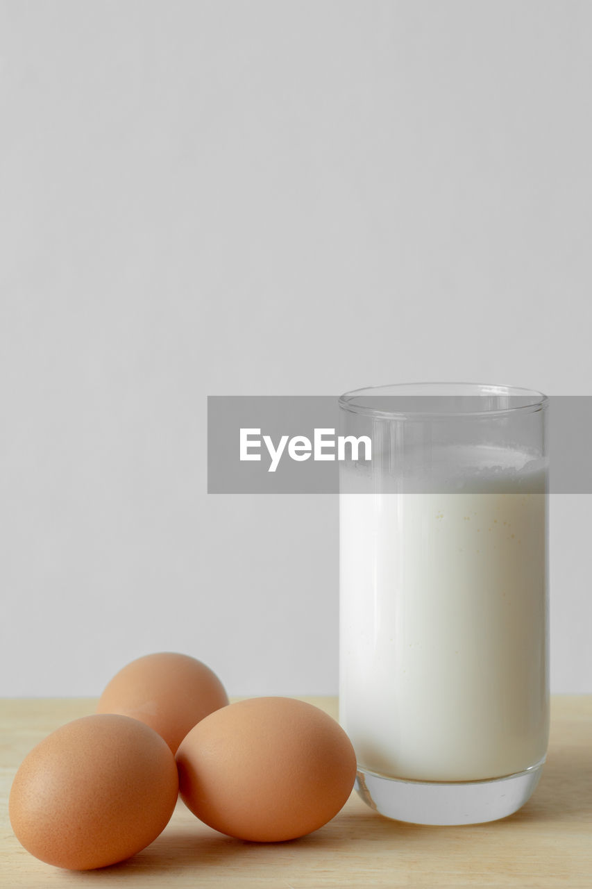 Close-up of eggs and milk on table