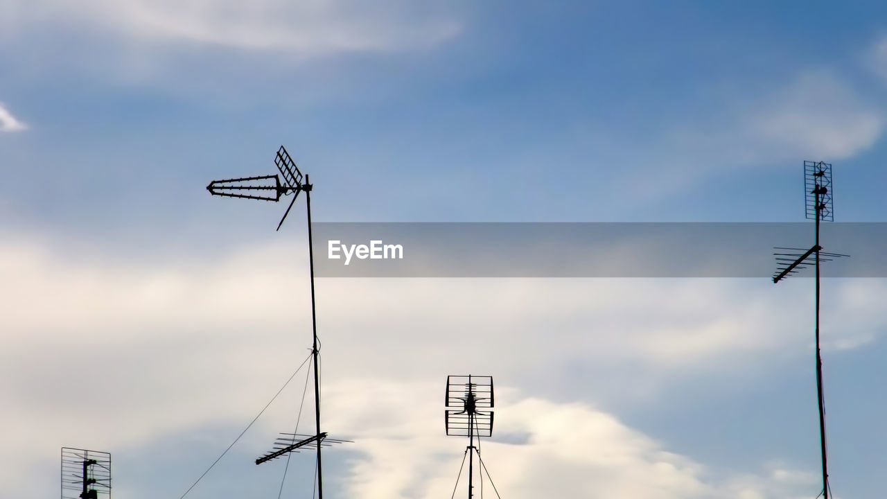 Low angle view of electricity pylon against sky