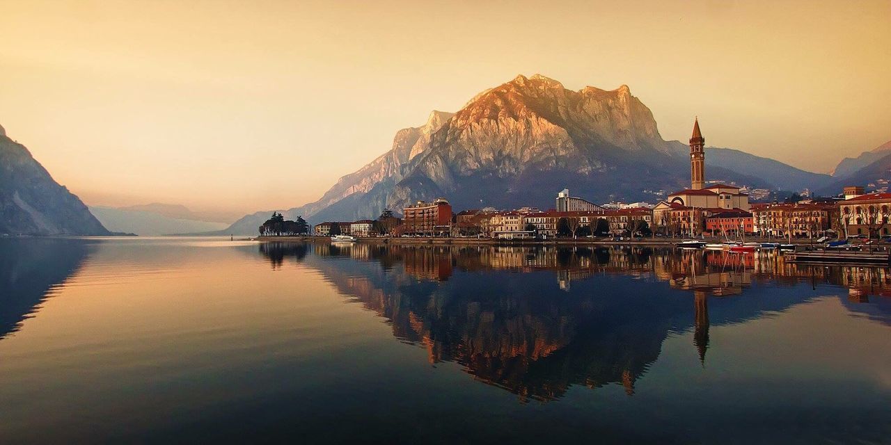 Reflection of city with mountain in lake